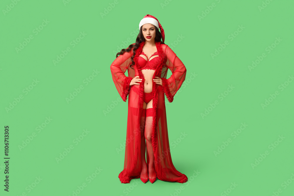 Beautiful young sexy woman in lingerie and Santa hat on green background Beautiful young sexy woman in lingerie and Santa hat on green background