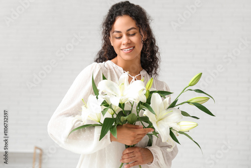 Smiling young woman holding...