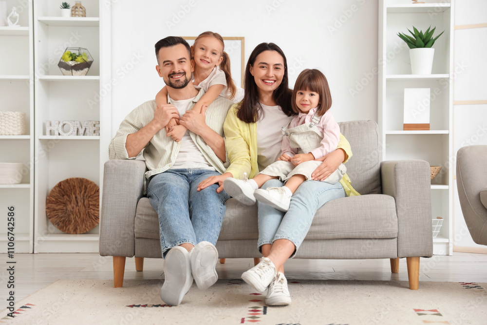Beautiful happy family sitting on sofa at home Beautiful happy family sitting on sofa at home