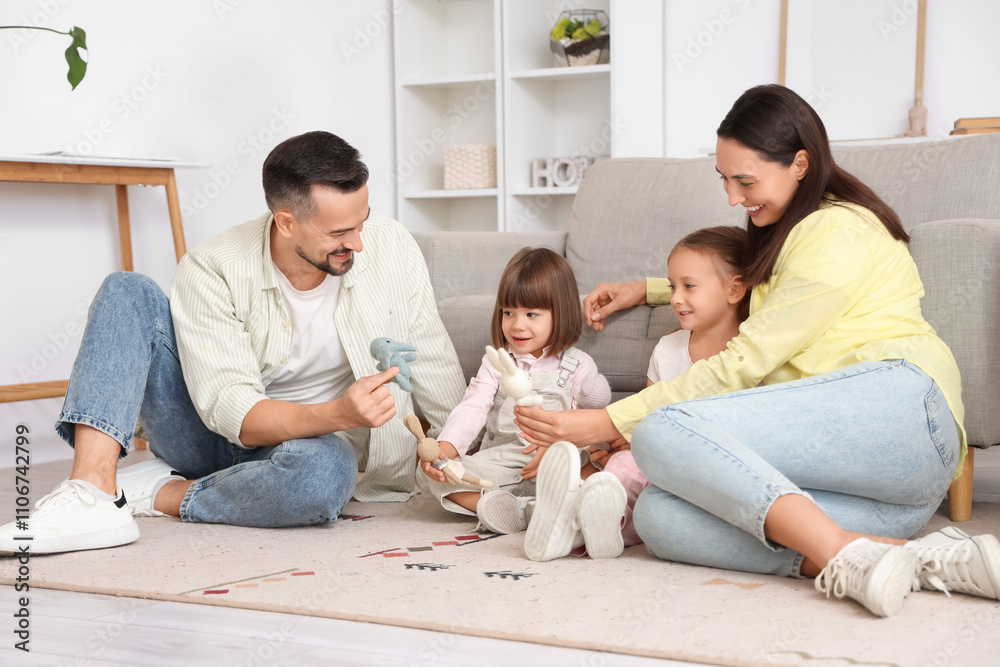 Happy family playing with cute toys on floor at home Happy family playing with cute toys on floor at home