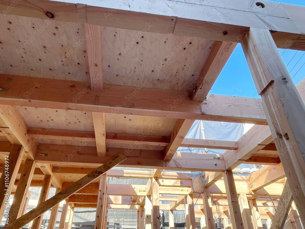 During construction of new unfinished residential home, wood framing supports beam in Japan