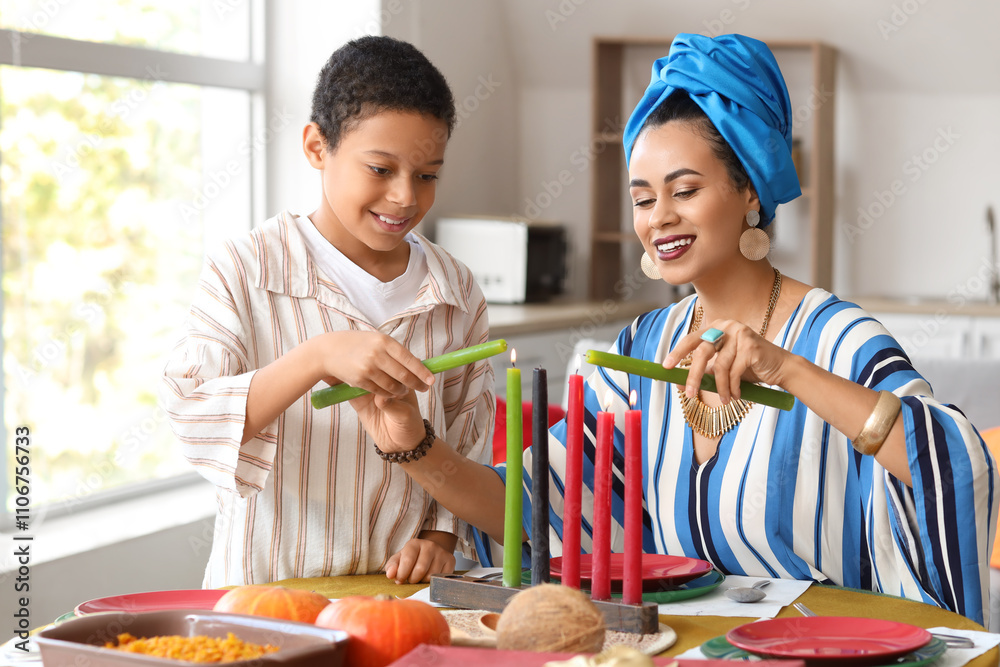 African-American mother with her son lighting up candles at home. Kwanzaa celebration African-American mother with her son lighting up candles at home. Kwanzaa celebration