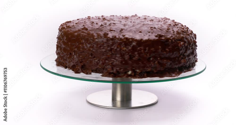 Homemade Chocolate Cake on a Glass Cake Stand for Dessert isolated on white background video Homemade Chocolate Cake on a Glass Cake Stand for Dessert isolated on white background video