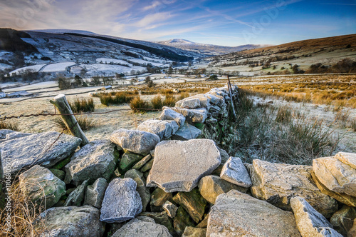 Frost covered dry stone wall in countryside