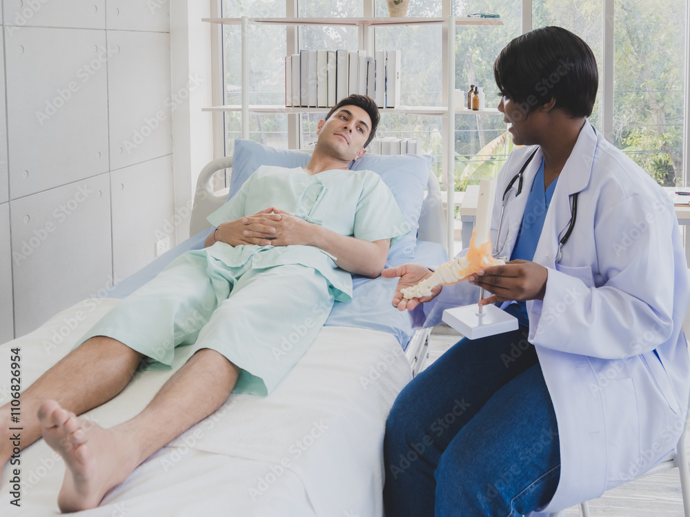 Portrait patient caucasian man with woman doctor nurse carer physical therapist black people two person sitting talk helping support give advice and holding relax check on leg body inside hospital Portrait patient caucasian man with woman doctor nurse carer physical therapist black people two person sitting talk helping support give advice and holding relax check on leg body inside hospital