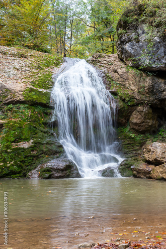a waterfall in the summer, rushing streams and jets of water and turned into a huge shower of water