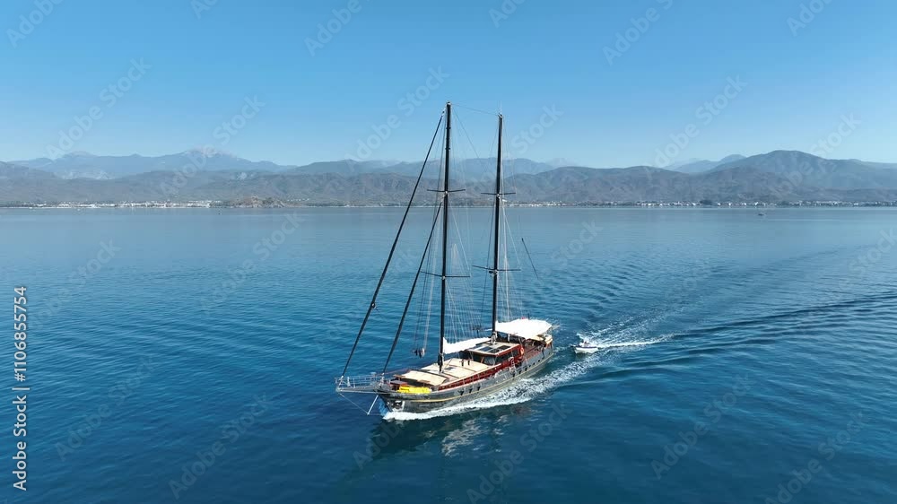A gulet ship passing along a rocky coastline, with clear turquoise waters and rugged cliffs providing a dramatic and stunning backdrop. A gulet ship passing along a rocky coastline, with clear turquoise waters and rugged cliffs providing a dramatic and stunning backdrop.