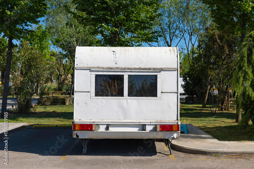 Rear of the travel trailer in the parking lot. Camping concept photo