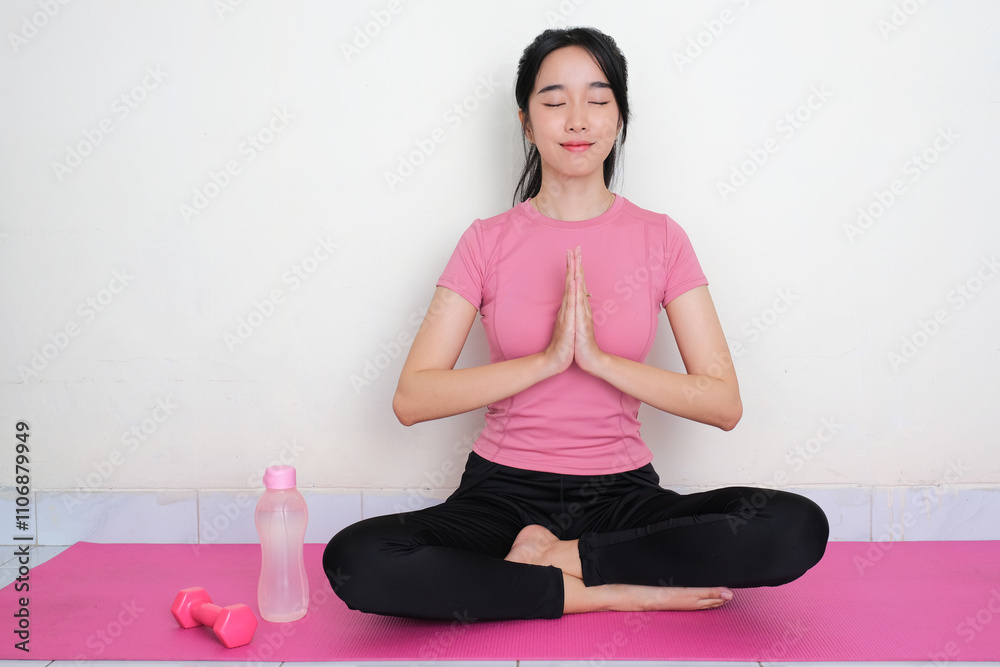 A woman doing yoga exercise sitting above yoga mat A woman doing yoga exercise sitting above yoga mat