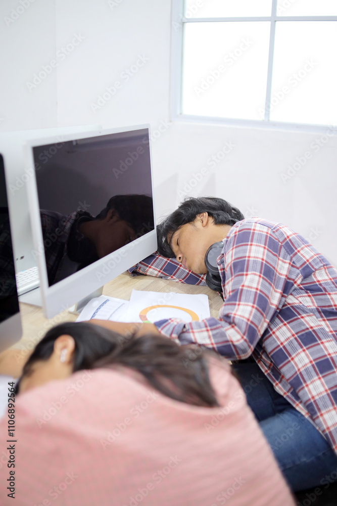 Fototapeta premium Tired Asian Students Sleeping In Classroom