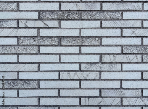 A gray brick wall background with texture and pattern