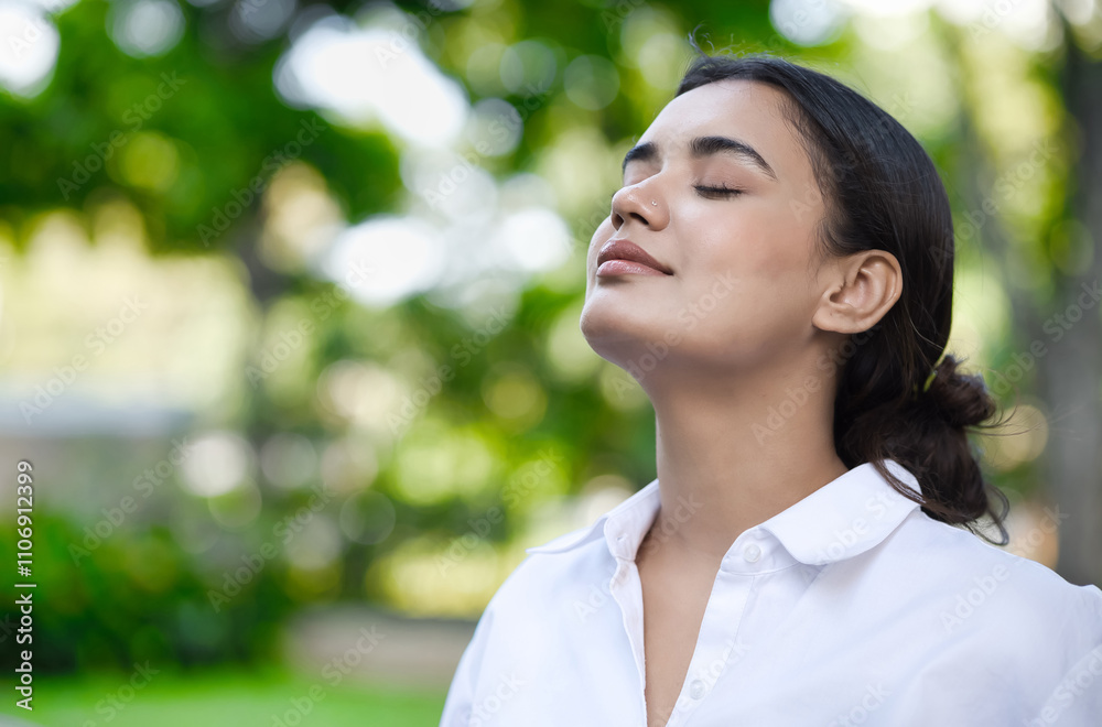 Fototapeta premium Relaxed happy refreshing young south asian woman taking a deep breath of clean unpolluted air in urban park, good summer, summer wellness, sunlight exposure concept image