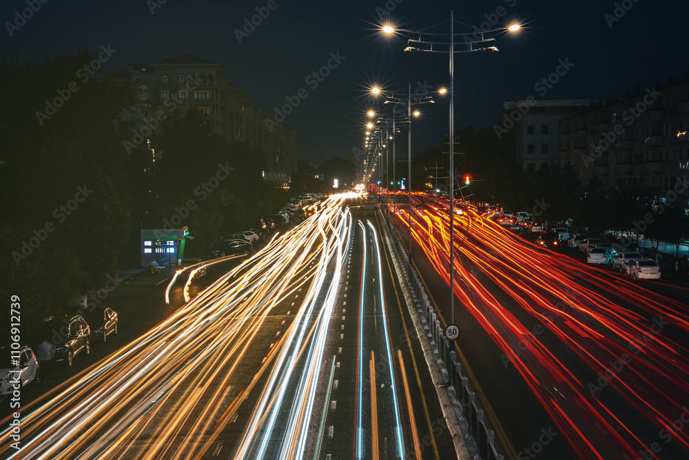 Obraz premium Blurred car traffic light at night city. Traffic jam in evening rush hour.
