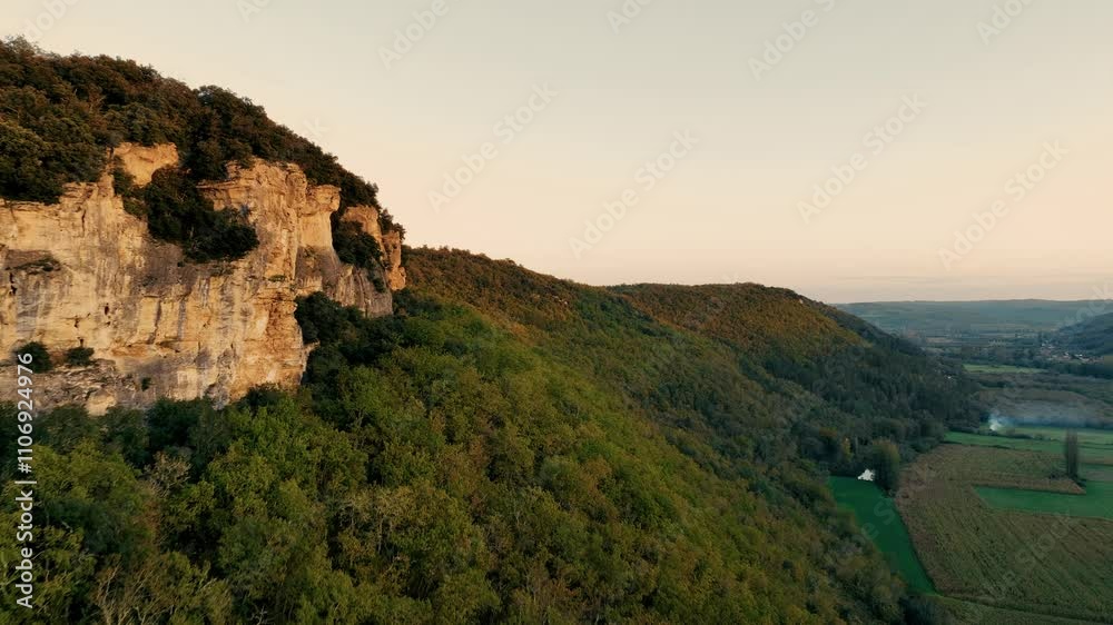 sunset on cliff in a forested valley, aerial view along the ridge sunset on cliff in a forested valley, aerial view along the ridge