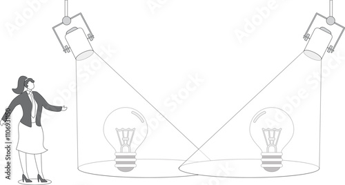 Businesswoman with spotlight and spotlit idea light bulb