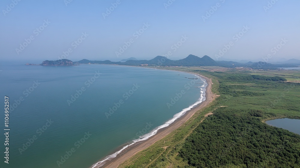 Aerial View of a Coastal Landscape with Mountains in the Distance Aerial View of a Coastal Landscape with Mountains in the Distance