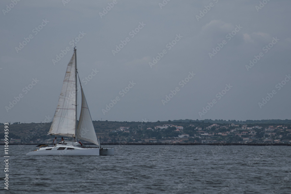 Sailboat Cruising Near the Coastline of Sète, France Sailboat Cruising Near the Coastline of Sète, France