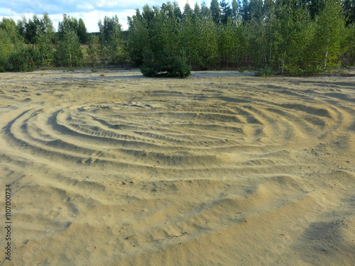 circles in the sand from ATV tires in Lopatinsky quarries photo