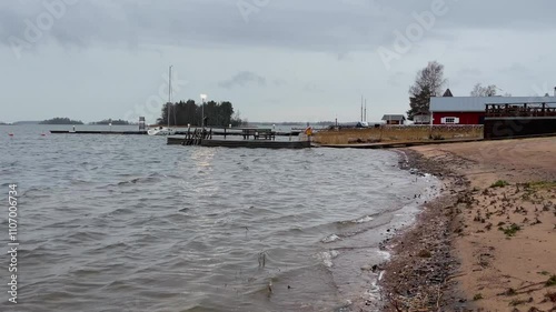 A Beautiful Serene Coastal Scene Featuring Numerous Boats Beneath Overcast, Gray Skies