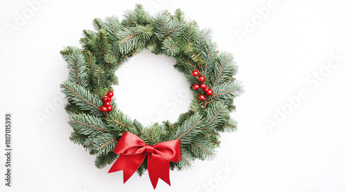 Christmas wreath with green pine branches and red ribbon isolate on white background photo