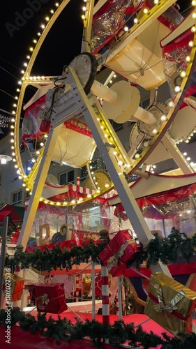 A vibrant Christmas market featuring a glowing ferris wheel, festive lights, and decorated stalls, creating a cheerful holiday ambiance.
