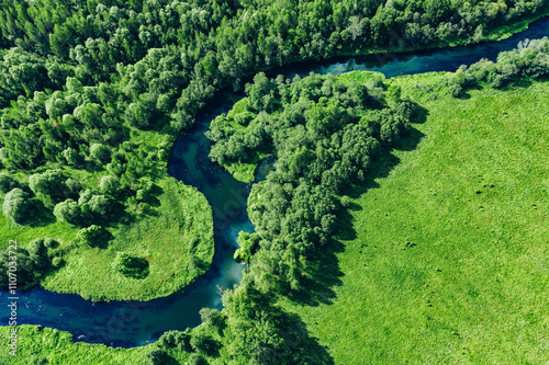 Fototapeta Naklejka Na Ścianę i Meble -  Aerial drone view of blue curved river and green summer woods