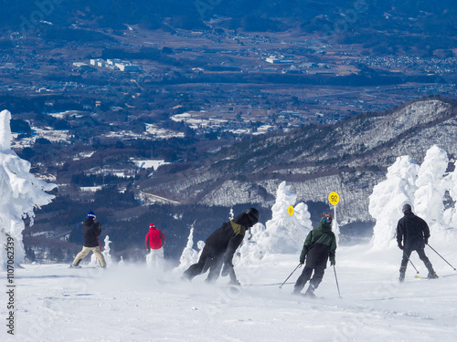 People going down in snow slope surrounded by ice monsters (Zao, Yamagata, Japan) photo