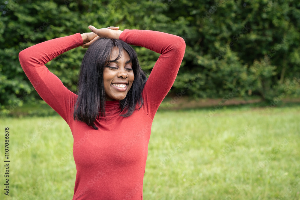 Joyful woman with raised arms expressing freedom and happiness outdoors Joyful woman with raised arms expressing freedom and happiness outdoors