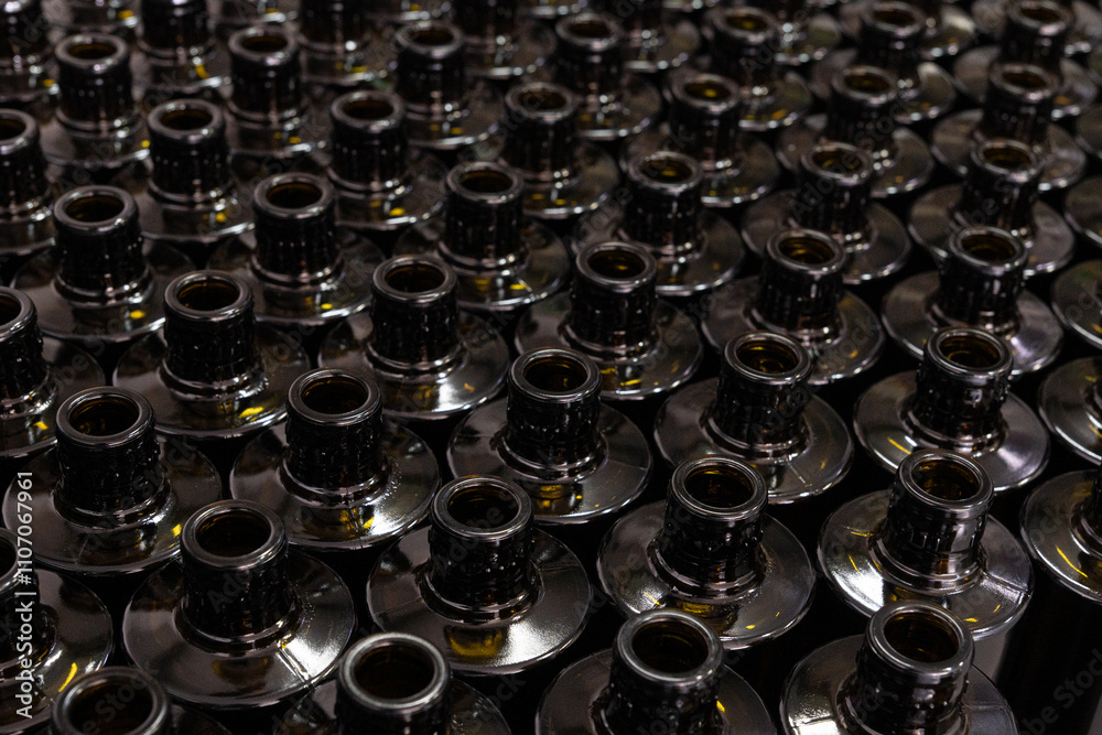 Dark glass bottles pattern in industrial oil production line, top view Dark glass bottles pattern in industrial oil production line, top view