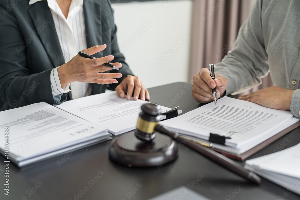 Lawyer Legal counsel presents to the client a signed contract with gavel and legal law. justice and lawyer Business partnership meeting concept Lawyer Legal counsel presents to the client a signed contract with gavel and legal law. justice and lawyer Business partnership meeting concept
