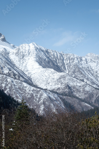 View of beautiful the mountain in sunny blue sky at Huanglong national scenic parkland in Sichun, China that covered with snow in winter season. Nature and outdoor scape photo. photo