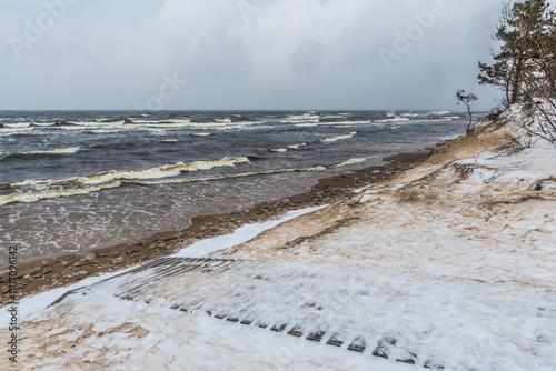 Fototapeta Naklejka Na Ścianę i Meble -  Footpath between winter Baltic Sea s dunes in Saulkrasti in Latvia