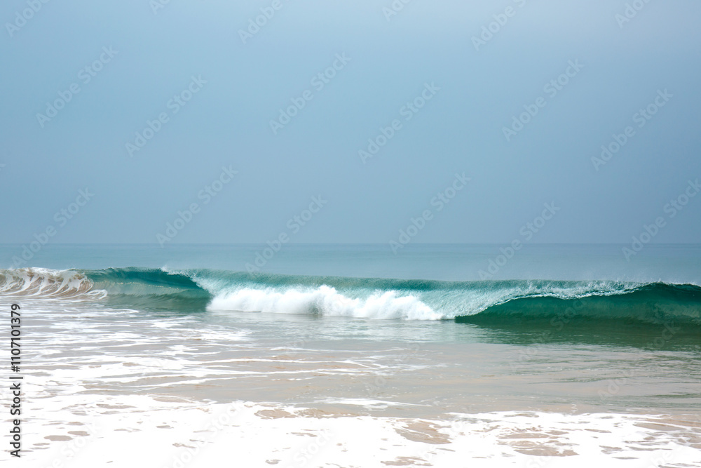 Beautiful blue waves with foam near the shore of the Ocean Beautiful blue waves with foam near the shore of the Ocean