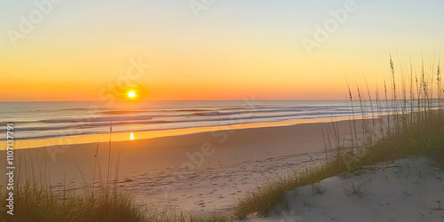 A serene beach sunset with golden sand, gentle waves, and the sun dipping below the horizon. The sky is painted in soft pinks and oranges, creating a tranquil and romantic vibe.