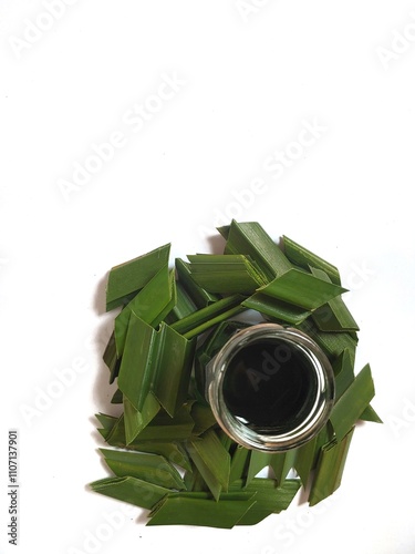 A jar filled with fresh, concentrated Pandan (pandanus amaryllifolius) extracted for flavoring and coloring food and dessert photo