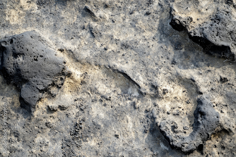 Textured volcanic ash, rugged gray and black particles with visible fine dust, bold and tactile