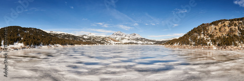 panoramic view of frozen lake in Pyrenees mountains