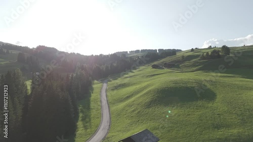 Aerial revealing shot of a mountain hut in the Alpi Di Siusi region in Italy photo