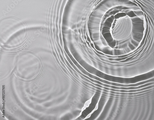 ripples in water with concentric shadow on white background 