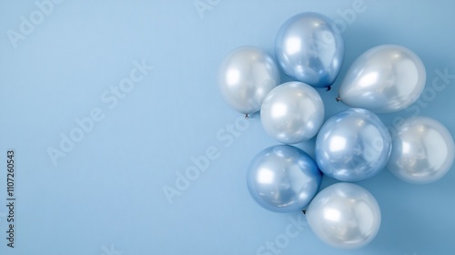 A collection of blue and silver balloons arranged on a light blue background.