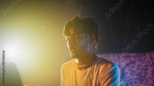 Couple of multiethnic dancers rehearsing or performing on stage in dance show. Attractive black man and beautiful mixed race lady, talented students of school of arts, slow motion, medium portrait