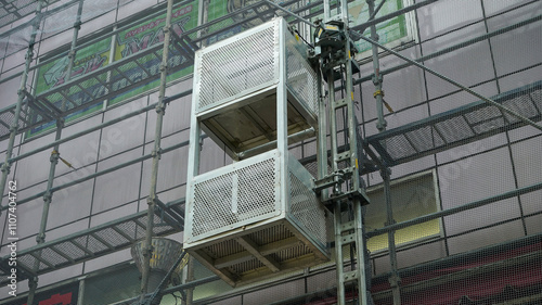 Elevator on the exterior wall of a building under construction in Japan