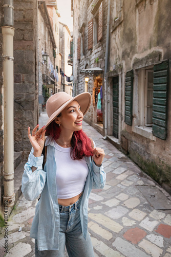 Tourist walking down narrow street in old european town
