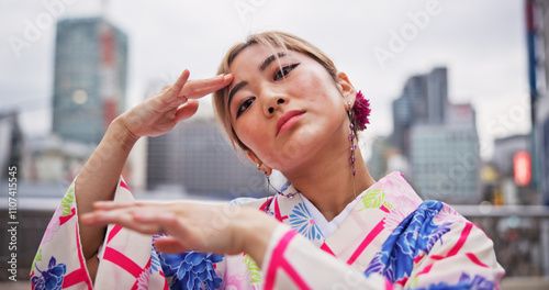 Japanese woman, culture and dance with kimono in city for hand movement, contemporary style and expression. Outdoor performer, portrait and nihon buyo with traditional fashion, urban town or heritage photo