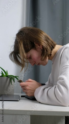 Slouched woman focused on smartphone.