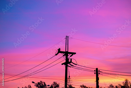 Bright pink sky with electric poles and power lines.
