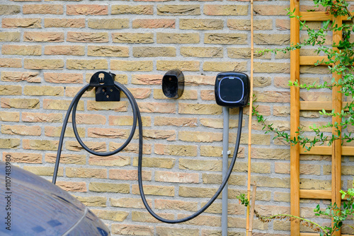 electric vehicle charger mounted on yellow brick wall, symbolizing sustainable energy solutions and the growing trend of electric vehicle infrastructure.