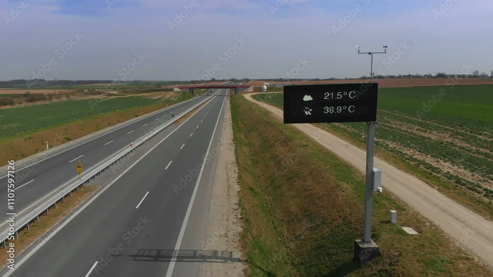 Good conditions on the road. Motorway and fields aerial shot. Highway with TIRs trucks and cars in Europe. 
