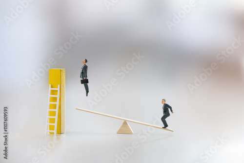 Workplace inequality, power dynamics, competition, and short cut to career growth : Miniatures figures, along with the seesaw and a ladder, highlight an imbalance or differing level of opportunity. photo