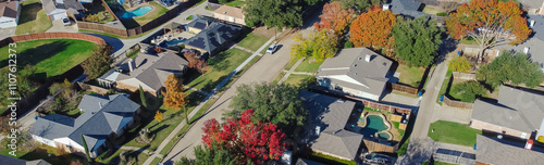Panorama aerial view residential street with colorful fall foliage over suburban houses shingle roof in Coppell, Dallas Fort Worth, Texas metroplex, fast growing suburbs housing market estate photo